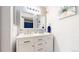 Bathroom with double sink vanity, decorative wall art, and modern lighting at 3600 S Pierce St # 5-202, Denver, CO 80235