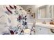 Bathroom featuring a floral shower curtain and white vanity with a vessel sink at 3600 S Pierce St # 5-202, Denver, CO 80235