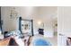 Bedroom with crib, reading chair, and alphabet rug near the window at 3600 S Pierce St # 5-202, Denver, CO 80235