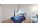 Bedroom with comfortable blue bedding, light blocking shades, and spacious layout at 3600 S Pierce St # 5-202, Denver, CO 80235
