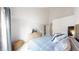 Bright bedroom features vaulted ceiling, television on dresser, and blue quilt bedding at 3600 S Pierce St # 5-202, Denver, CO 80235