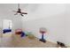 Bonus room features ceiling fan and is currently purposed as a play space at 3600 S Pierce St # 5-202, Denver, CO 80235