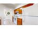 Practical kitchen with wood cabinets and standard appliances for comfortable cooking at 3600 S Pierce St # 5-202, Denver, CO 80235
