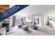 Bright living room features vaulted ceilings, a cozy fireplace, and sliding glass doors at 3600 S Pierce St # 5-202, Denver, CO 80235