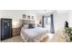 Relaxing main bedroom with a decorative headboard, plush bedding, and natural light at 3600 S Pierce St # 5-202, Denver, CO 80235