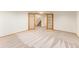 Basement area with a staircase, carpet flooring, and french doors at 9346 Lark Sparrow Dr, Highlands Ranch, CO 80126