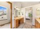 Bathroom with vanity area and sink, with a view to a bedroom, and an exterior window at 9346 Lark Sparrow Dr, Highlands Ranch, CO 80126