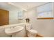 Half bathroom featuring a large mirror, white sink and natural light at 9346 Lark Sparrow Dr, Highlands Ranch, CO 80126