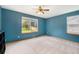 Bright bedroom with large windows offering views of the landscaped backyard at 9346 Lark Sparrow Dr, Highlands Ranch, CO 80126