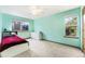 Cozy bedroom featuring bright teal walls, two windows, and white dresser with a ceiling fan at 9346 Lark Sparrow Dr, Highlands Ranch, CO 80126