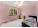 A cute pink bedroom with a window, bed, dresser, and a ceiling fan at 9346 Lark Sparrow Dr, Highlands Ranch, CO 80126