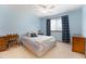 Bedroom with blue walls, a window with curtains, bed, ceiling fan and furnishings at 9346 Lark Sparrow Dr, Highlands Ranch, CO 80126