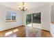 Bright dining room with hardwood floors, chandelier lighting, and sliding glass door to the backyard deck at 9346 Lark Sparrow Dr, Highlands Ranch, CO 80126