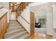 Spacious entryway with hardwood floors, a carpeted staircase, and a view into the living room at 9346 Lark Sparrow Dr, Highlands Ranch, CO 80126