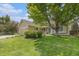 Inviting two-story home with well-maintained lawn, mature trees, and a charming, covered front porch at 9346 Lark Sparrow Dr, Highlands Ranch, CO 80126