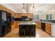 Eat-in kitchen features wood cabinetry, granite countertops and a black kitchen island at 9346 Lark Sparrow Dr, Highlands Ranch, CO 80126