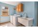 Functional laundry room features a utility sink, cabinet and laundry machines at 9346 Lark Sparrow Dr, Highlands Ranch, CO 80126