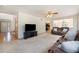 Cozy living room featuring plush seating, ceiling fan, and open access to the entryway and kitchen at 9346 Lark Sparrow Dr, Highlands Ranch, CO 80126
