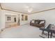 Bright living room with plush seating, ceiling fan, and open access to the dining room and staircase at 9346 Lark Sparrow Dr, Highlands Ranch, CO 80126