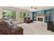 Inviting living room featuring a cozy fireplace, comfortable seating, and ample natural light from large windows at 9346 Lark Sparrow Dr, Highlands Ranch, CO 80126