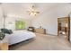 Vaulted main bedroom features neutral walls, carpet floors and large windows at 9346 Lark Sparrow Dr, Highlands Ranch, CO 80126