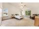 Spacious main bedroom with vaulted ceilings, carpet floors and multiple windows at 9346 Lark Sparrow Dr, Highlands Ranch, CO 80126