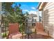 Relaxing balcony with chairs, offering a serene outdoor space to enjoy views of the property's landscaped yard at 13824 E Lehigh Ave # B, Aurora, CO 80014