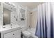Clean bathroom featuring neutral tile and a shower-tub combo, maximizing space and functionality at 13824 E Lehigh Ave # B, Aurora, CO 80014