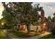 Charming condo with mature tree and a brick chimney at dusk at 13824 E Lehigh Ave # B, Aurora, CO 80014