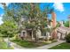 Charming condo with mature tree and a brick chimney on a sunny day at 13824 E Lehigh Ave # B, Aurora, CO 80014