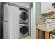 Convenient laundry area with stacked washer and dryer, maximizing space and efficiency at 13824 E Lehigh Ave # B, Aurora, CO 80014