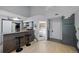 Cozy living area with a kitchen bar, opening into a bedroom creating an inviting and functional living space at 13824 E Lehigh Ave # B, Aurora, CO 80014