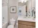 Clean bathroom with tub and shower combo, white vanity, and framed art at 3285 Belleville Ridge Rd, Elizabeth, CO 80107