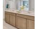 Bathroom featuring double vanity, quartz countertops, and a white tile shower at 3285 Belleville Ridge Rd, Elizabeth, CO 80107