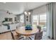 Dining area with wooden table, decorative chandelier, and sliding glass doors to outdoor patio at 3285 Belleville Ridge Rd, Elizabeth, CO 80107