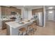 Modern kitchen featuring wooden cabinets and an island with stools for casual dining at 3285 Belleville Ridge Rd, Elizabeth, CO 80107