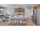 Bright kitchen features an island with bar seating, stainless steel appliances, and wood-look flooring at 3285 Belleville Ridge Rd, Elizabeth, CO 80107