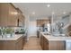 Modern kitchen with stainless steel appliances, tile backsplash, and adjacent breakfast nook at 3285 Belleville Ridge Rd, Elizabeth, CO 80107