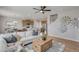 Comfortable living room featuring an open floor plan and a large, decorative ceiling fan at 3285 Belleville Ridge Rd, Elizabeth, CO 80107