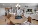 Open concept living and dining areas feature modern decor, wood floors, and lots of natural light at 3285 Belleville Ridge Rd, Elizabeth, CO 80107