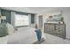 Bright main bedroom with a large dresser, bright window, and light carpet at 3285 Belleville Ridge Rd, Elizabeth, CO 80107