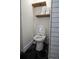 Modern bathroom features sleek hexagonal tile flooring and rustic wood shelving for extra storage at 8950 W 26Th, Lakewood, CO 80215
