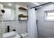 Bright bathroom featuring modern fixtures, a stylish sink, and a spacious shower with black hardware at 8950 W 26Th, Lakewood, CO 80215