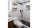 Modern bathroom showcasing white subway tile, black fixtures, and sleek design elements at 8950 W 26Th, Lakewood, CO 80215