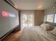 Comfortable bedroom featuring a large projection screen and sliding doors leading to the outdoors at 8950 W 26Th, Lakewood, CO 80215