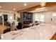 Open-concept kitchen flowing into the living room with marble counter seating at 8950 W 26Th, Lakewood, CO 80215