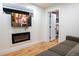 Modern living room with fireplace and mounted television at 8950 W 26Th, Lakewood, CO 80215