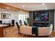 Bright living room featuring hardwood floors, modern fireplace, and a large screen tv at 8950 W 26Th, Lakewood, CO 80215