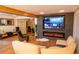 Inviting living room featuring a fireplace and a large screen TV at 8950 W 26Th, Lakewood, CO 80215