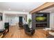 Spacious open-concept living area featuring a modern fireplace and built-in shelving at 8950 W 26Th, Lakewood, CO 80215